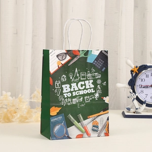 Green Back to School paper gift bag with school supplies illustration and white handles