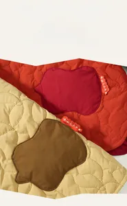 Detail of wave quilted texture and contrast patches on children's winter cotton vest