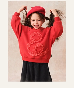 Detailed view of red winter sweatshirt with creative ruffle circular pattern and soft fleece