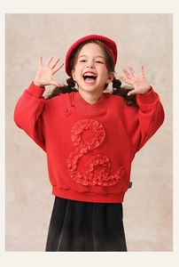 Detail of red winter sweatshirt featuring unique textured ruffle & design for girls
