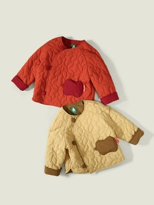 Quilted winter jackets for kids with wave stitching and apple-shaped pockets in warm tones