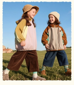 Kids outdoor hooded color-block jackets styled in a scenic outdoor park setting