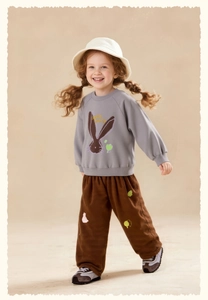 Detail of gray kids sweatshirt with Little Bunny print and brown corduroy pants