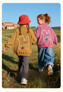 Detail of pixel-style cat patch on corduroy baseball jackets for girls in ginger and pink