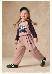 Close-up of kids pink corduroy wide-leg pants and matching long sleeve t-shirt outfit