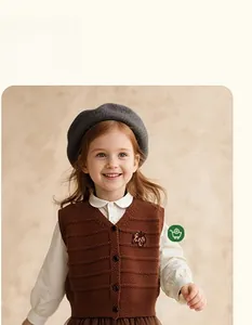 Detailed view of dark brown knitted girls vest with flower embroidery and V-neckline