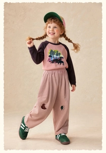 Detailed view of children pink corduroy wide-leg trousers with cute tree embroidery