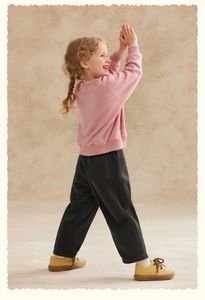 Detail of kids pink crewneck sweatshirt and dark grey corduroy wide-leg pants set