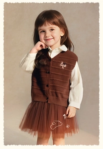 Detail of girls brown knit vest with butterfly embroidery and layered tulle skirt set