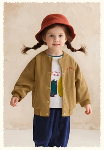 Detail of girls mustard corduroy jacket with embroidered logo and cat print t-shirt