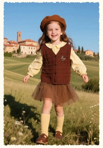 Detail of sweet girls' knit vest with butterfly embroidery and vintage rustic style outfit