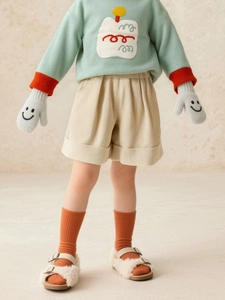 Girls sage green knit sweater and beige corduroy shorts set with rolled cuffs