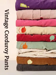 Stack of vintage kids' corduroy trousers in multi-color with cute cartoon embroidery