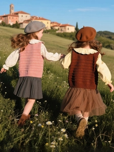 Girls sweet autumn knit vest set with bow decor and pleated skirt in outdoor park