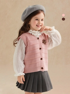 Girl's pink knit sleeveless sweater vest with bow detail and vintage buttons in prep style