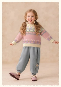 Detail of pink floral knit sweater and grey jogger pants for girls spring outfit