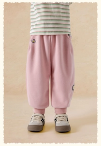 Detail view of pink cotton trousers featuring delicate floral embroidery and ribbed cuffs