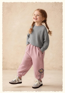 Girl's grey knit sweater and pink floral print jogger pants set with sneakers