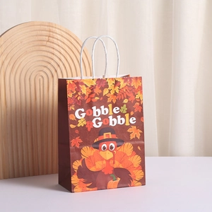Thanksgiving turkey gift bag with Gobble Gobble text and maple leaf prints