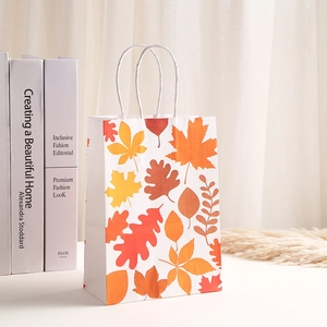 White kraft paper gift bag featuring vibrant maple leaf patterns and twisted rope handles
