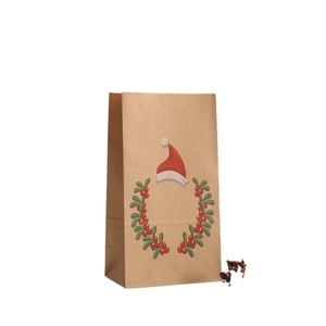 Sacchetto regalo di Natale in carta kraft con ghirlanda di agrifoglio e scritte oro