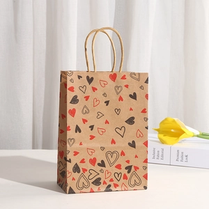 Brown kraft paper gift bag with red and black hearts and twisted paper handles