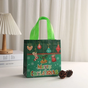 Green Merry Christmas non-woven gift bag with holiday bells and festive ornaments
