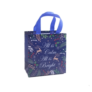 Blue Christmas non-woven gift bag with gold reindeer and All is Calm All is Bright text