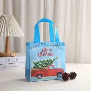 Blue Christmas tote bag with red truck and Merry Christmas text in cozy home setting