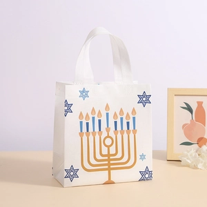 White Hanukkah non-woven gift bag featuring golden Menorah and blue Star of David