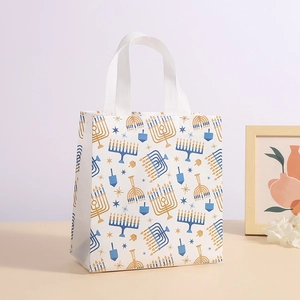 Hanukkah non-woven gift bag with blue menorah and dreidel prints for festive shopping