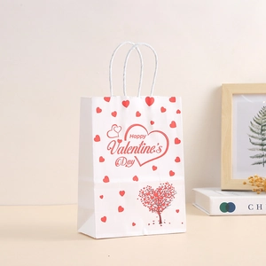 White Valentine's Day paper gift bag with red heart pattern and woven handles