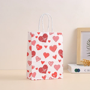 White kraft paper gift bag with red heart patterns and white rope handles for Valentine