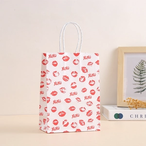 White kraft paper gift bag with red lip print and XOXO text for romantic occasions