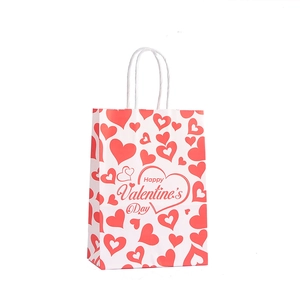Kraft paper Valentine gift bag with red hearts and Happy Valentine's Day text