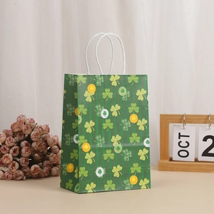 Detail of St. Patrick's Day paper gift bag with green clover pattern and rope handles