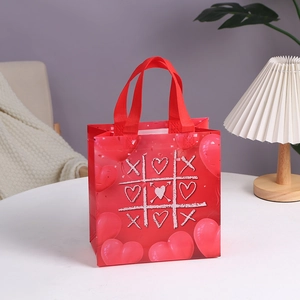 Red non-woven Valentine gift bag with romantic tic-tac-toe heart print and handles