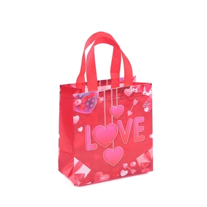 Red non-woven fabric gift bag with pink LOVE text and hearts for Valentine's Day party