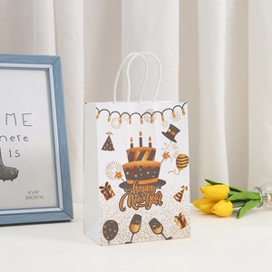 Happy New Year gift bag made of white cardstock with gold cake design and white handles