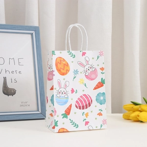 Detail of Easter paper gift bag with cartoon rabbit prints and white rope handles