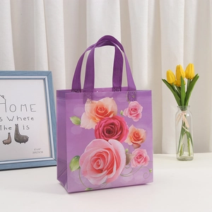 Purple non-woven floral gift bag with roses and sturdy handles for Mother's Day