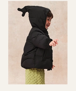 Detail of children's black quilted down jacket with cute hood ornaments and warm lining
