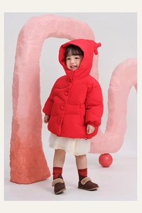 Detail of red hooded puffer jacket with large round buttons and warm insulated texture