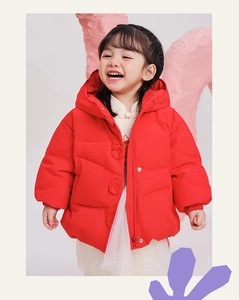 Close-up of children's red winter hooded down jacket with stylish cloth-wrapped buttons