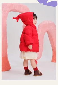 Detail of red winter puffer jacket with cute 3D reindeer antlers on the hood for kids