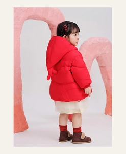 Detail of red hooded winter coat for kids featuring cute decorative horns and ribbed cuffs