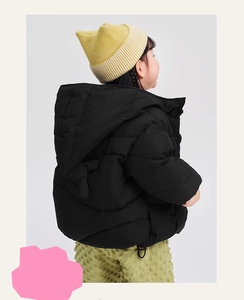 Rear view of child in black hooded quilted puffer jacket for winter outdoor wear