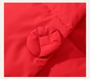 Detail of red winter jacket showing high-quality fabric texture and matching fabric button