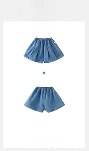 Girl's blue denim shorts featuring butterfly embroidery and pleated elastic waist details
