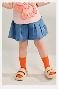 Detail of girls denim pleated shorts with butterfly embroidery and pink bunny t-shirt